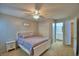 Comfortable bedroom with ceiling fan, closet, and ensuite bathroom at 658 Lake Dexter Cir, Winter Haven, FL 33884