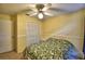 This cozy bedroom features a ceiling fan, closet and warm color palette at 658 Lake Dexter Cir, Winter Haven, FL 33884