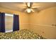 Bedroom with ceiling fan, window, and neutral walls for a relaxing atmosphere at 658 Lake Dexter Cir, Winter Haven, FL 33884