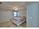 This bedroom features a bed, fan, nightstand and window, providing comfort and natural light at 658 Lake Dexter Cir, Winter Haven, FL 33884