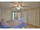Bright bedroom featuring a ceiling fan, multiple closets and neutral tones at 658 Lake Dexter Cir, Winter Haven, FL 33884