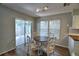 Cozy dining area with a sliding glass door, tile floors, and an abundance of natural light at 658 Lake Dexter Cir, Winter Haven, FL 33884