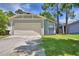 Charming single-Gathering home featuring an attached two-car garage and a well-maintained lawn at 658 Lake Dexter Cir, Winter Haven, FL 33884