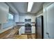 Modern kitchen featuring butcher block counters, stainless steel appliances, and white cabinetry at 658 Lake Dexter Cir, Winter Haven, FL 33884