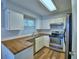 Well-equipped kitchen featuring butcher block counters, stainless steel appliances and white cabinetry at 658 Lake Dexter Cir, Winter Haven, FL 33884