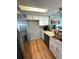 Modern kitchen featuring white cabinets, stainless steel appliances, and granite countertops at 7906 Waterview Way # 7906, Winter Haven, FL 33884