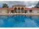 Community swimming pool with lounge chairs in front of the clubhouse at 7906 Waterview Way # 7906, Winter Haven, FL 33884