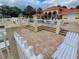 Community pool area with lounge chairs, landscaping, and a tiled roof clubhouse at 7906 Waterview Way # 7906, Winter Haven, FL 33884