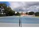 Community tennis courts with a view of the clubhouse and surrounding trees at 7906 Waterview Way # 7906, Winter Haven, FL 33884