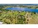 Expansive aerial view showcasing the property's large lot, mature trees, and proximity to a serene lake at 836 S Lake Starr Blvd, Lake Wales, FL 33898
