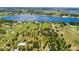 Expansive aerial view showcasing the property's large lot, mature trees, and proximity to a serene lake at 836 S Lake Starr Blvd, Lake Wales, FL 33898