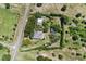 Aerial view showcases the property layout, perimeter trees, and outbuildings at 836 S Lake Starr Blvd, Lake Wales, FL 33898