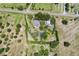 Aerial view of a private residence surrounded by mature trees and lush landscaping, offering tranquility and seclusion at 836 S Lake Starr Blvd, Lake Wales, FL 33898
