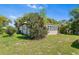Home's backyard featuring mature trees at 836 S Lake Starr Blvd, Lake Wales, FL 33898