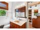 Bathroom with sink and window with view to lush tropical landscape at 836 S Lake Starr Blvd, Lake Wales, FL 33898