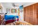 Cozy bedroom features closet, ceiling fan, tv and bright natural light at 836 S Lake Starr Blvd, Lake Wales, FL 33898