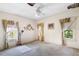 Bedroom with three windows, ceiling fan, and carpet at 836 S Lake Starr Blvd, Lake Wales, FL 33898