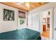 Cozy bedroom with wood ceiling, closet space, and an en-suite bathroom featuring natural light from the window at 836 S Lake Starr Blvd, Lake Wales, FL 33898