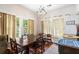 Bright dining room featuring a wooden table, decorative chandelier, and natural light from large windows at 836 S Lake Starr Blvd, Lake Wales, FL 33898