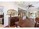 View from dining room showing a large mirror, hardwood floors, and a glimpse of the living room at 836 S Lake Starr Blvd, Lake Wales, FL 33898