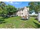View of rear of home showing exterior and yard with mature trees at 836 S Lake Starr Blvd, Lake Wales, FL 33898