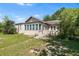 Exterior shot of home with screened porch and large grassy yard at 836 S Lake Starr Blvd, Lake Wales, FL 33898