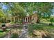 Charming home with mature trees, a covered porch, and a lush front lawn at 836 S Lake Starr Blvd, Lake Wales, FL 33898