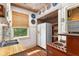 Functional kitchen with retro stove, double sinks, quirky decor, and a window providing natural light at 836 S Lake Starr Blvd, Lake Wales, FL 33898