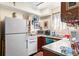 Efficient kitchen with wood cabinets and basic appliances, designed for convenience at 836 S Lake Starr Blvd, Lake Wales, FL 33898