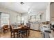 Cozy eat-in kitchen with patterned wallpaper, white cabinets, and vintage appliances at 836 S Lake Starr Blvd, Lake Wales, FL 33898