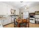 Kitchen showcasing white cabinets, a vintage stove, and a cozy dining area with retro wallpaper at 836 S Lake Starr Blvd, Lake Wales, FL 33898