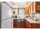Functional kitchen with wood cabinets, essential appliances, and ample counter space at 836 S Lake Starr Blvd, Lake Wales, FL 33898
