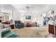 Comfortable living room with floral sofa and recliner, featuring a ceiling fan and classic decor at 836 S Lake Starr Blvd, Lake Wales, FL 33898