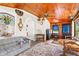 Cozy living room featuring a wood ceiling, fireplace, and decorative stained-glass at 836 S Lake Starr Blvd, Lake Wales, FL 33898
