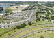 An aerial view of a residential neighborhood with homes, streets, and green spaces at 8720 Micmac Ct, Polk City, FL 33868