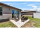 A furnished back patio area provides a relaxing outdoor living space at 8720 Micmac Ct, Polk City, FL 33868