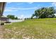 Large backyard with grass and a white fence at 8720 Micmac Ct, Polk City, FL 33868