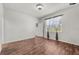 Bedroom featuring hardwood floors and a large window at 8720 Micmac Ct, Polk City, FL 33868