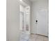 Bright hallway with tile floors leading to various rooms in the home, showcasing an open floor plan at 8720 Micmac Ct, Polk City, FL 33868