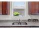 Close up of a kitchen sink with view to the outside at 8720 Micmac Ct, Polk City, FL 33868