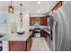 Modern kitchen featuring stainless steel appliances, granite countertops, and dark wood cabinetry at 8720 Micmac Ct, Polk City, FL 33868