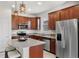 Modern kitchen with stainless steel appliances, granite countertops, and ample cabinet space at 8720 Micmac Ct, Polk City, FL 33868