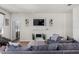 Comfortable living area with modern fixtures, a cozy fireplace, and open access to the kitchen area at 8720 Micmac Ct, Polk City, FL 33868