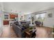 Spacious living area featuring hardwood flooring, large windows, and access to an open kitchen at 8720 Micmac Ct, Polk City, FL 33868