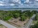 Aerial view of property with mature trees, proximity to a lake, and street access at 914 Mangham Rd, Babson Park, FL 33827