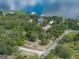 Aerial view of property with mature trees, a home, and proximity to a lake at 914 Mangham Rd, Babson Park, FL 33827