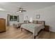 This bright bedroom features two twin beds, stylish bedding, wood-look flooring and a ceiling fan at 914 Mangham Rd, Babson Park, FL 33827