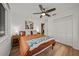 Comfortable bedroom with a queen bed, wood floors, a ceiling fan, and closet space at 914 Mangham Rd, Babson Park, FL 33827