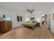 Bright bedroom with a large bed, wooden dresser, and ceiling fan, offering a comfortable and relaxing retreat at 914 Mangham Rd, Babson Park, FL 33827