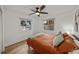 Bright bedroom featuring water views, a queen bed, wood floors, and natural light at 914 Mangham Rd, Babson Park, FL 33827